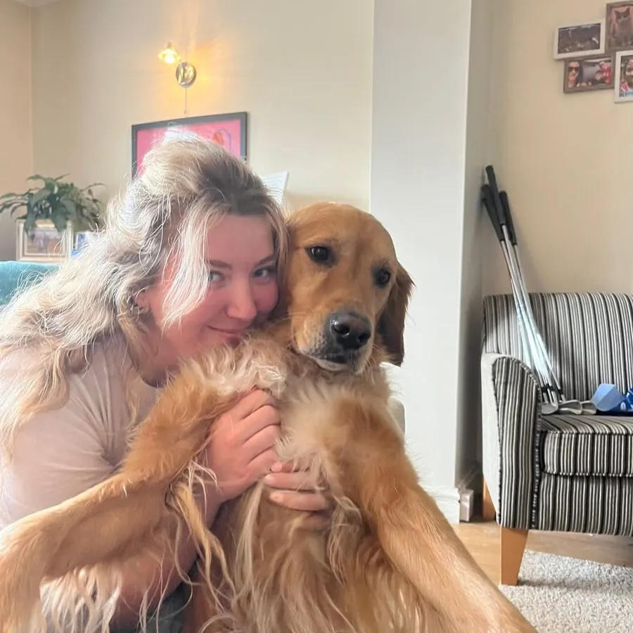 Me cuddling a golden retriever